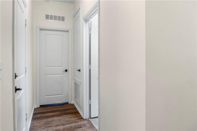 corridor featuring dark hardwood / wood-style floors