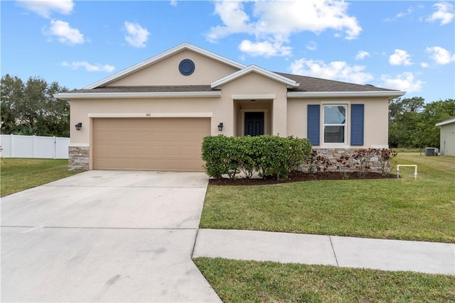 ranch-style home with a garage and a front lawn