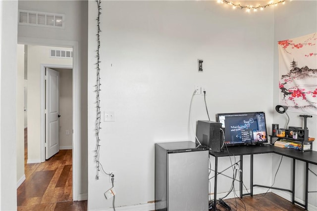 office with dark wood-type flooring