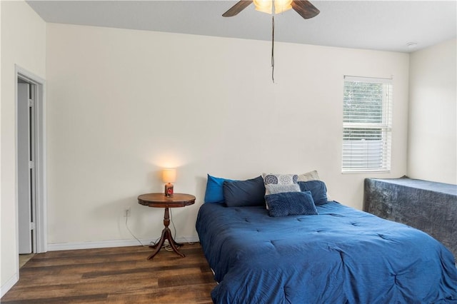 bedroom with ceiling fan and dark wood-type flooring