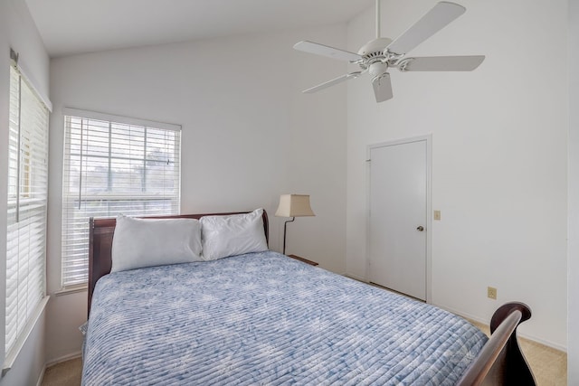 carpeted bedroom with high vaulted ceiling and ceiling fan