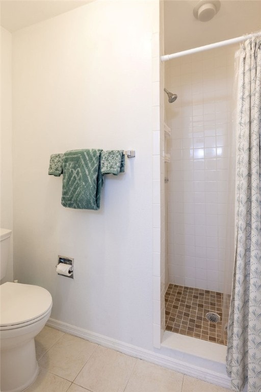 bathroom with toilet, tile patterned floors, and a shower with curtain