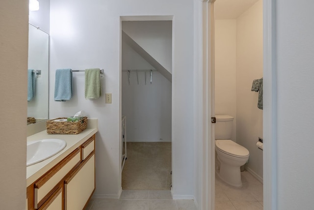 bathroom featuring vanity, tile patterned flooring, and toilet