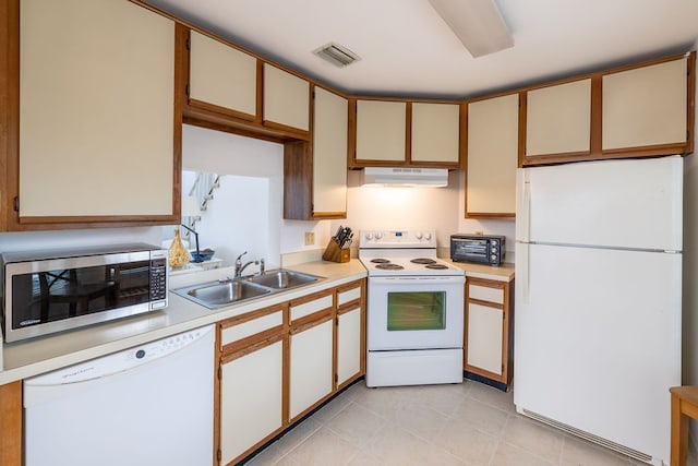 kitchen with white appliances, sink, and light tile patterned flooring