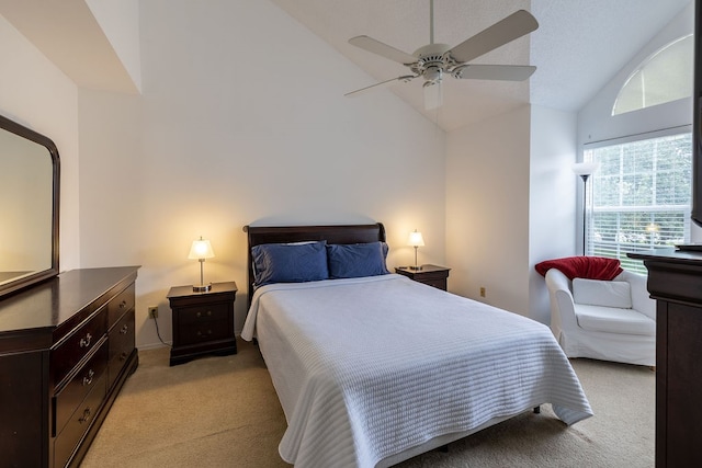 bedroom with ceiling fan, light carpet, and high vaulted ceiling