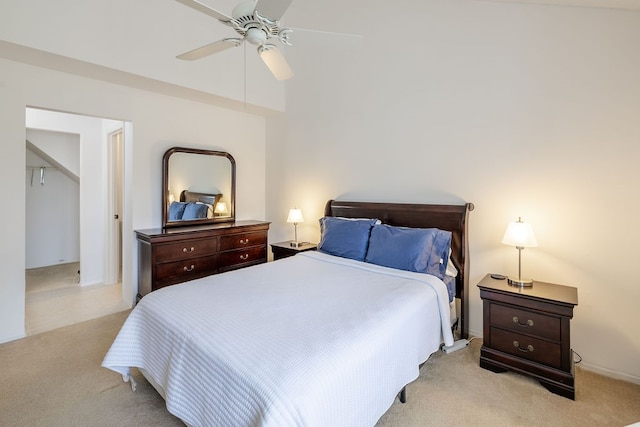 carpeted bedroom with ceiling fan and vaulted ceiling