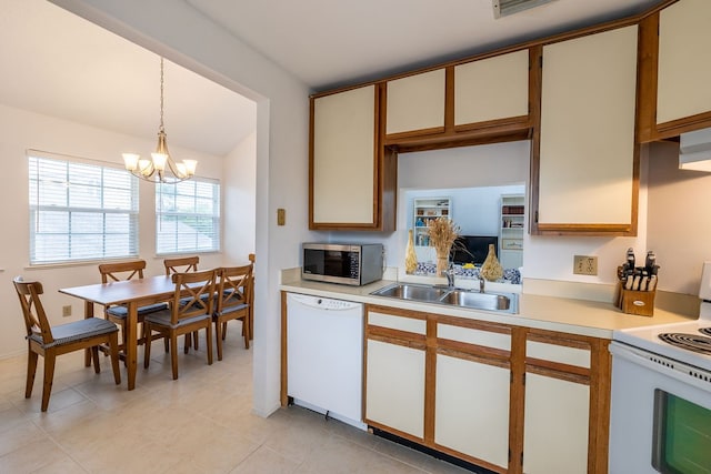 kitchen with white cabinetry, decorative light fixtures, sink, an inviting chandelier, and white appliances