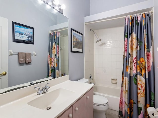 full bathroom with vanity, shower / tub combo with curtain, and toilet