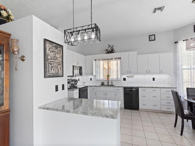 kitchen featuring sink, backsplash, black appliances, white cabinets, and decorative light fixtures