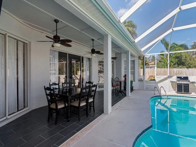 view of pool with ceiling fan, grilling area, a lanai, and a patio area