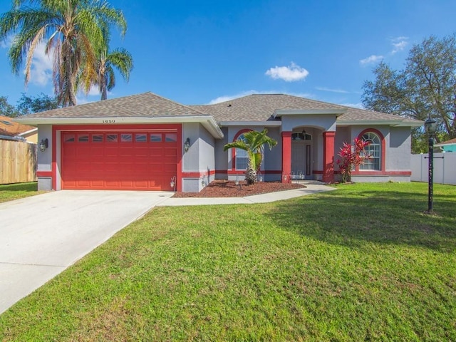 ranch-style house featuring a garage and a front yard