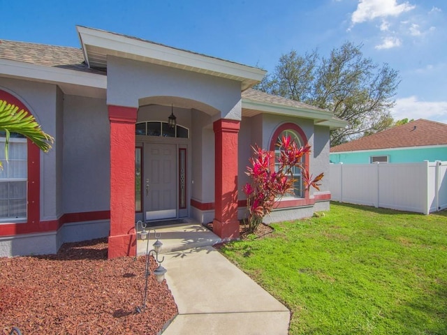 doorway to property with a yard