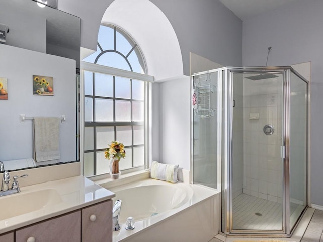 bathroom featuring shower with separate bathtub, vanity, and tile patterned floors