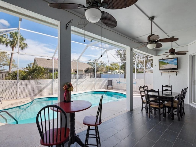 view of pool featuring a patio, ceiling fan, and glass enclosure