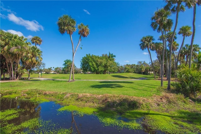 view of home's community featuring a water view and a yard