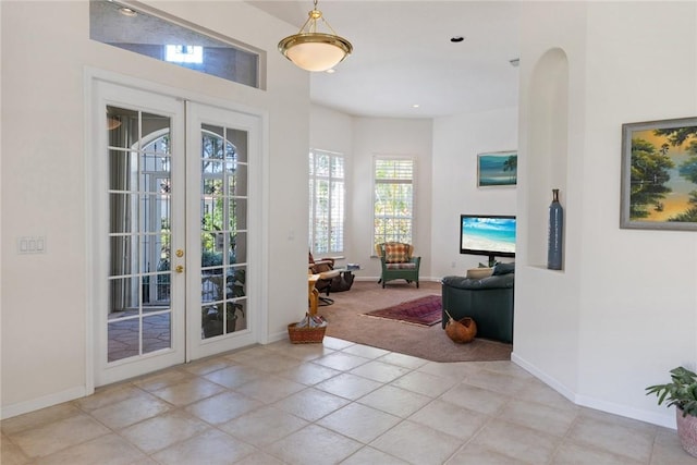 doorway to outside featuring light carpet and french doors