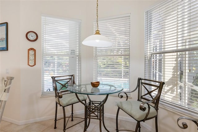 dining space featuring light tile patterned flooring