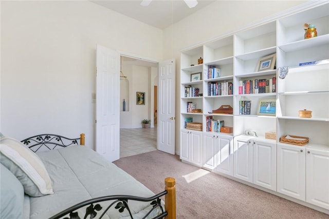 bedroom featuring ceiling fan and light carpet