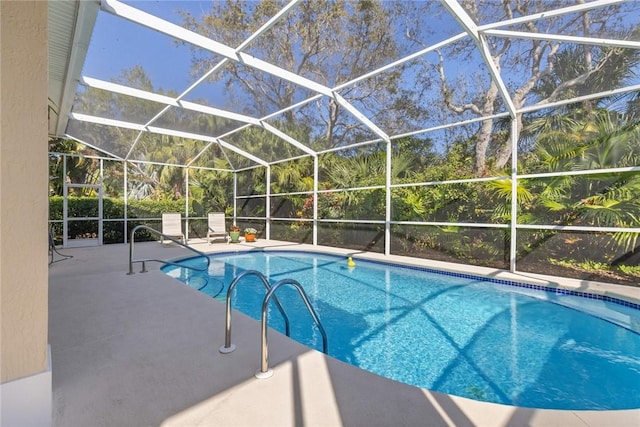 view of swimming pool with a patio area and glass enclosure