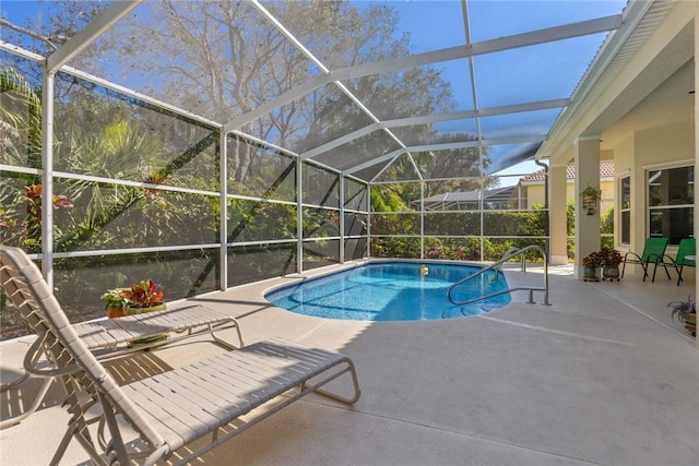 view of pool with a patio and glass enclosure