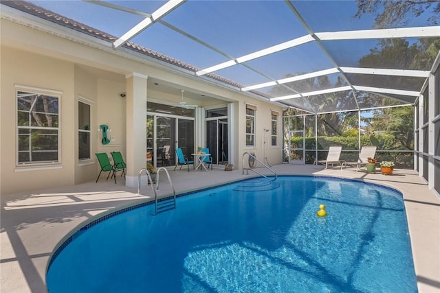 view of swimming pool with a lanai, a patio, and ceiling fan