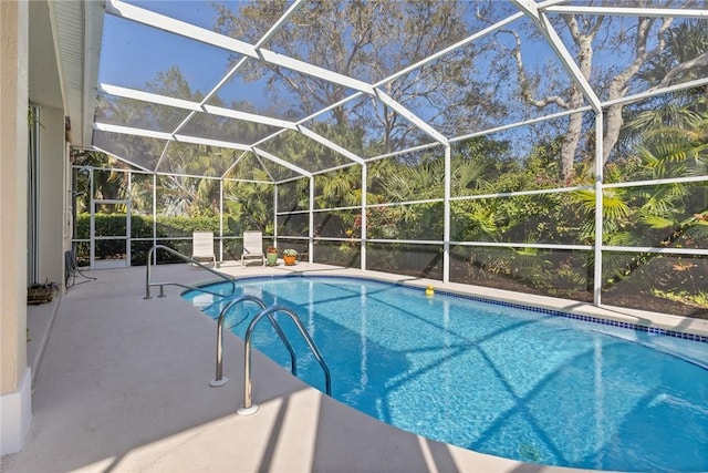 view of pool featuring a patio and glass enclosure