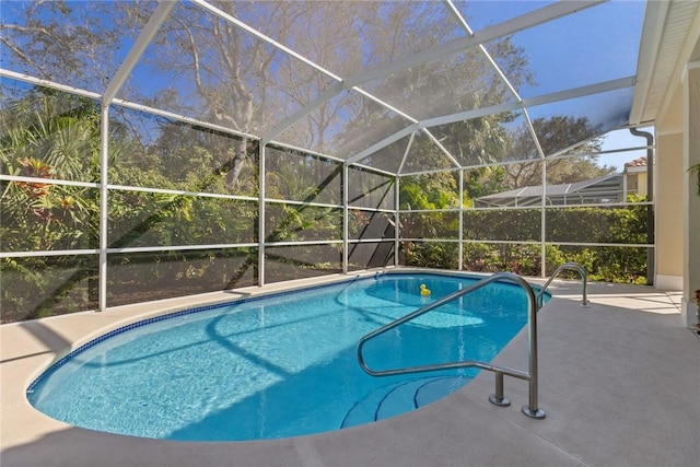 view of swimming pool featuring a patio area and glass enclosure