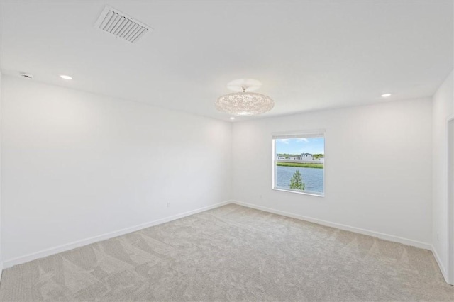 unfurnished room featuring light carpet, baseboards, and recessed lighting