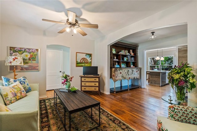 living room with hardwood / wood-style flooring and ceiling fan