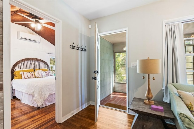 bedroom with wood-type flooring and a wall mounted AC