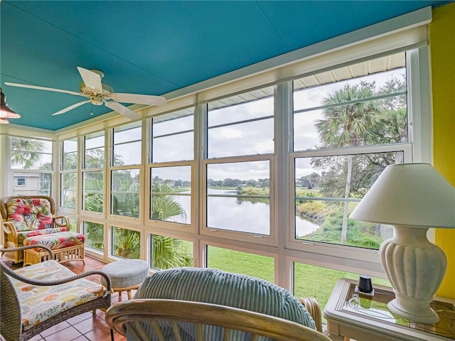 sunroom / solarium with a water view, a wealth of natural light, and ceiling fan