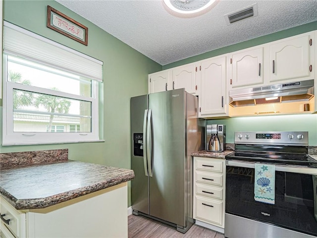 kitchen featuring white cabinetry, appliances with stainless steel finishes, a textured ceiling, and light hardwood / wood-style flooring