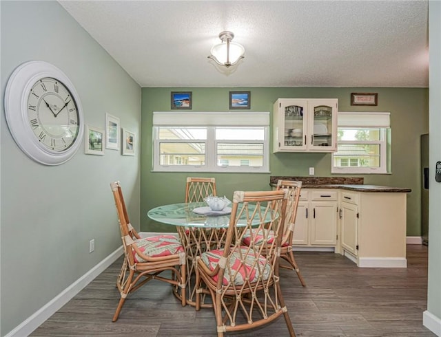 dining area with hardwood / wood-style flooring and a textured ceiling