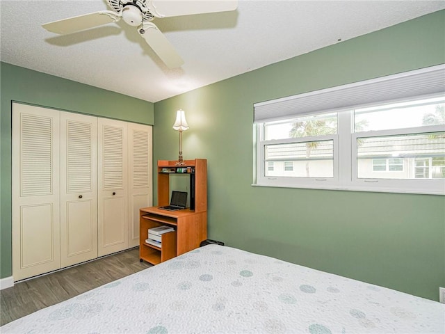 bedroom featuring hardwood / wood-style floors, a closet, and ceiling fan