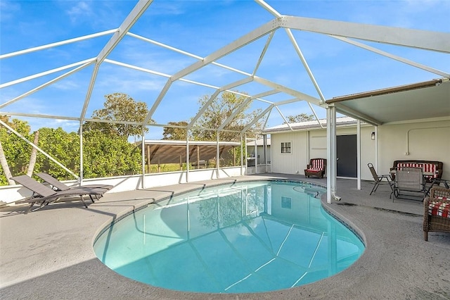 view of pool featuring glass enclosure and a patio area