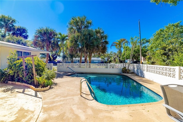 view of pool with a patio area, a fenced in pool, and fence