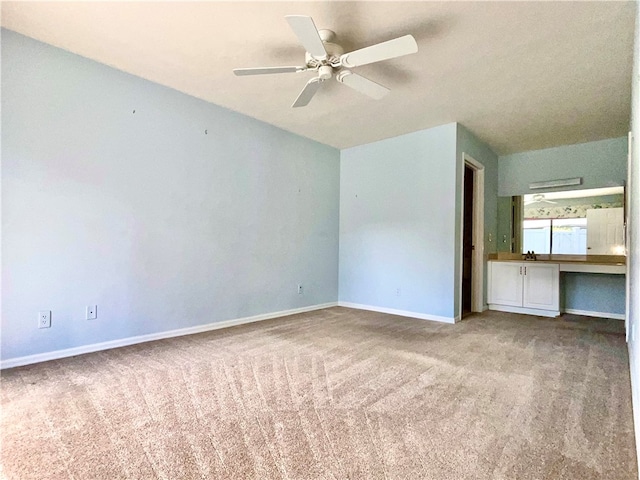 unfurnished bedroom with ceiling fan and light colored carpet