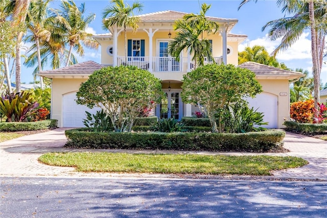 mediterranean / spanish-style house with a garage and french doors