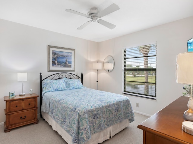 bedroom featuring ceiling fan and light carpet