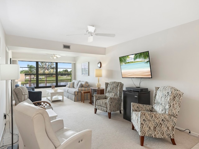 living room with ceiling fan and light colored carpet