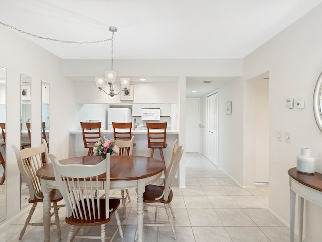 tiled dining space with a notable chandelier