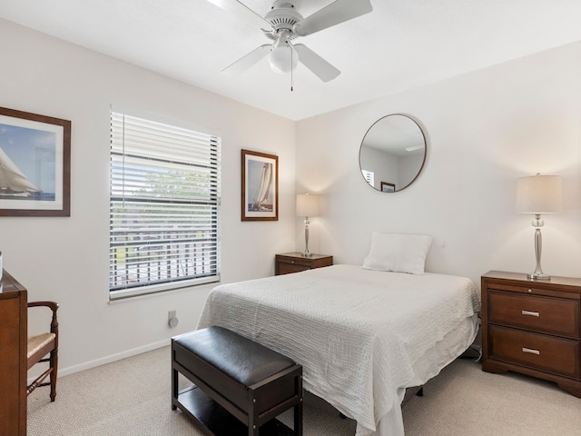 bedroom featuring ceiling fan and light carpet