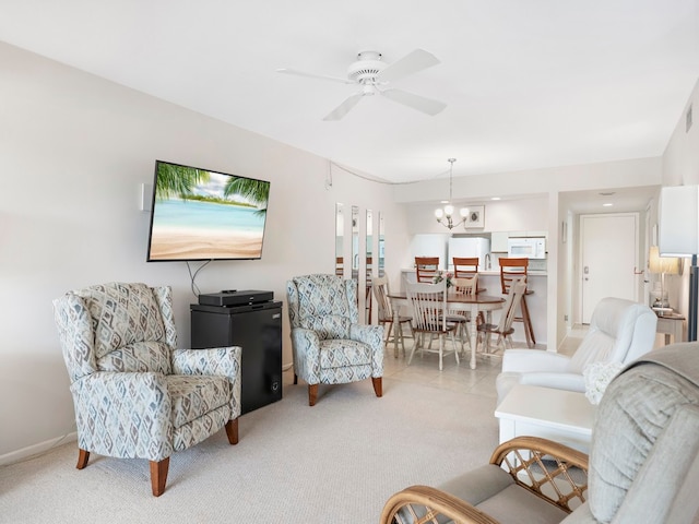 living room with ceiling fan with notable chandelier