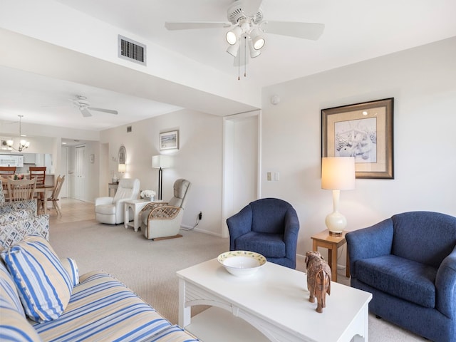 living room with a chandelier and light carpet