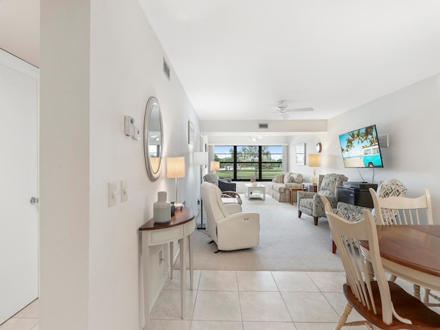 living room featuring ceiling fan and light colored carpet