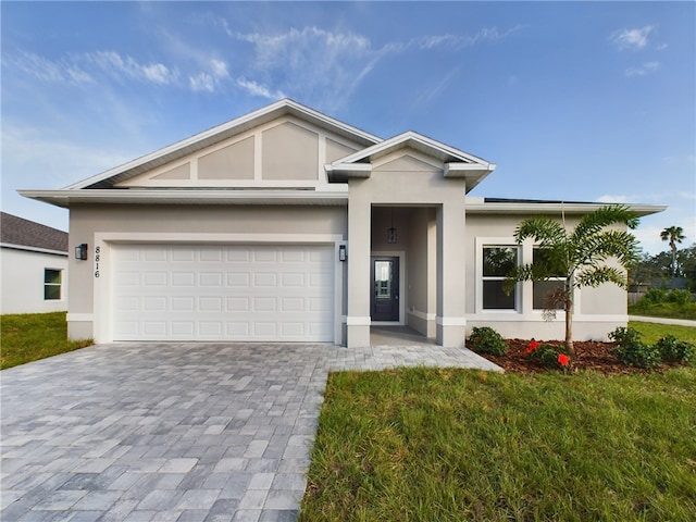 view of front of house featuring a garage and a front lawn