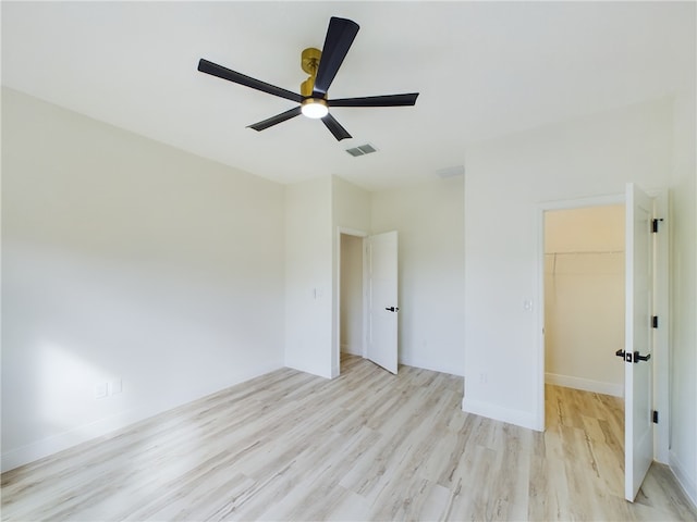 unfurnished room with ceiling fan and light wood-type flooring