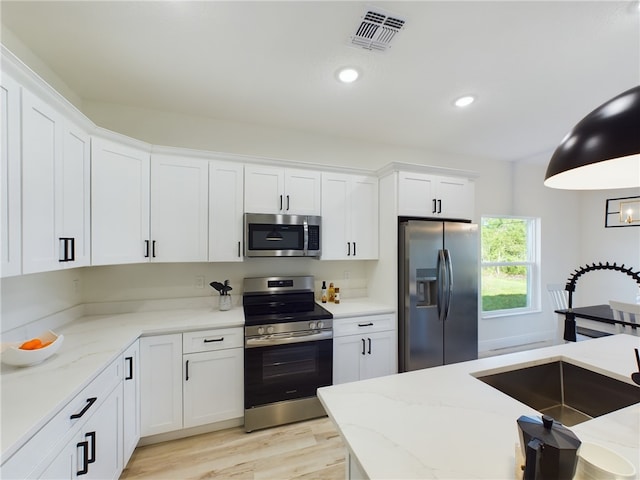 kitchen with white cabinetry, sink, and appliances with stainless steel finishes