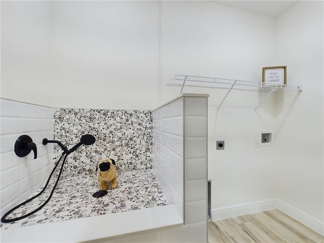 laundry room with washer hookup and hardwood / wood-style floors