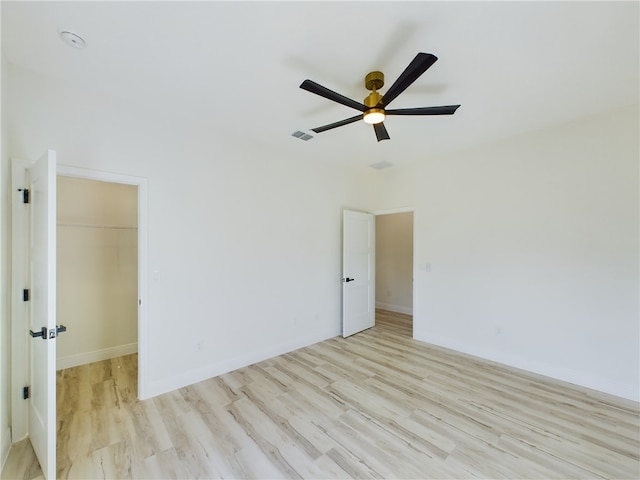 spare room with ceiling fan and light hardwood / wood-style floors